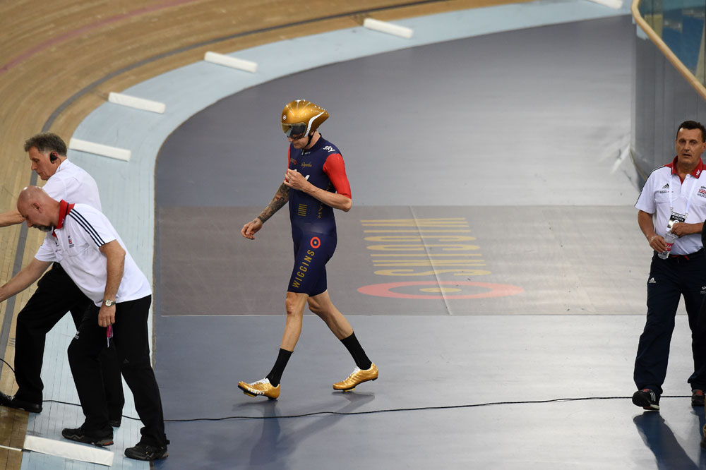Bradley Wiggins walks to his bike with the sellout crowd cheering him on
