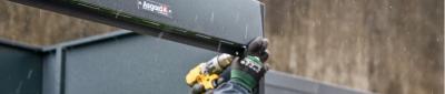 Installation team building a bike shed