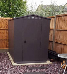 A modern patio leags to this asgard garden storage